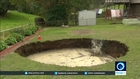 VIDEO: Couple wake up to find growing sinkhole in back garden
