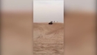Arabs drifting on a sand dune